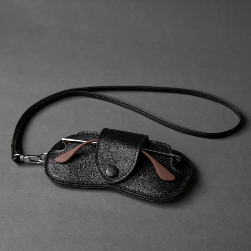 Black PU leather eyewear storage case with a leather strap and silver clasp.