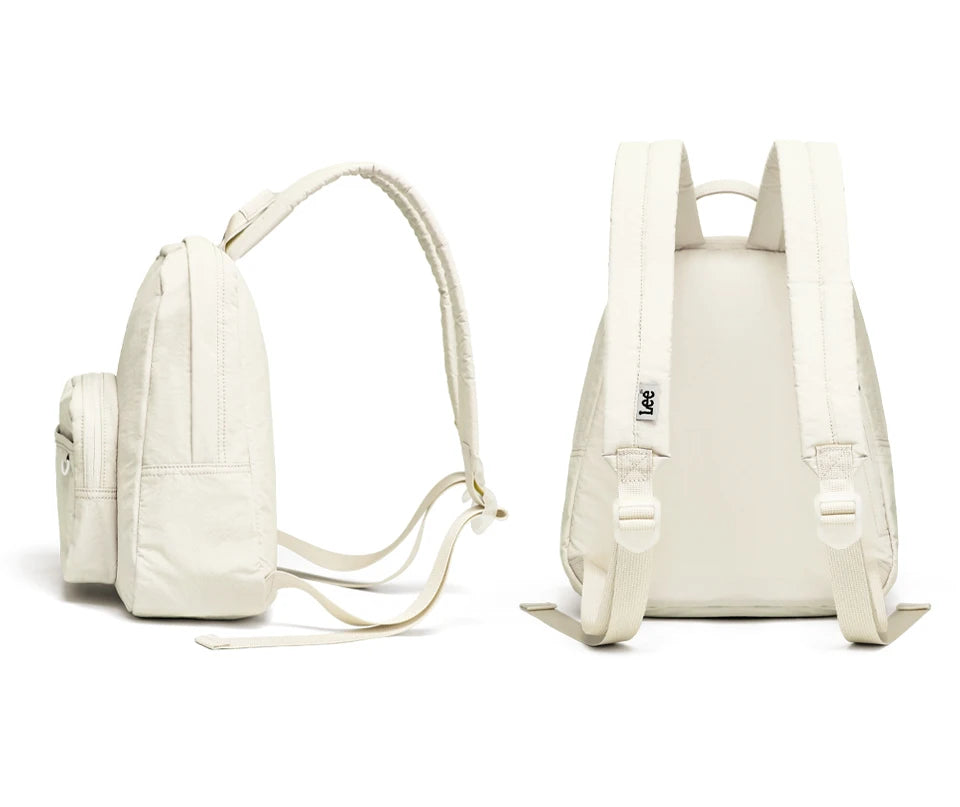 A cream-colored lightweight waterproof daypack with a padded back panel and adjustable straps.