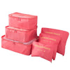 A set of pink laundry pouches and storage bags for travel organization.