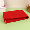 A vibrant red felt cosmetic bag insert organizer lying on a light green surface.