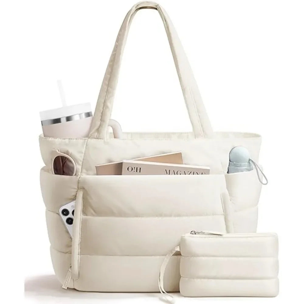 A cream quilted puffer tote bag with pockets and a matching pouch shown in a studio setting.