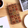 A patterned bohemian wood-grain leather wallet with multiple card slots resting on a wooden surface.