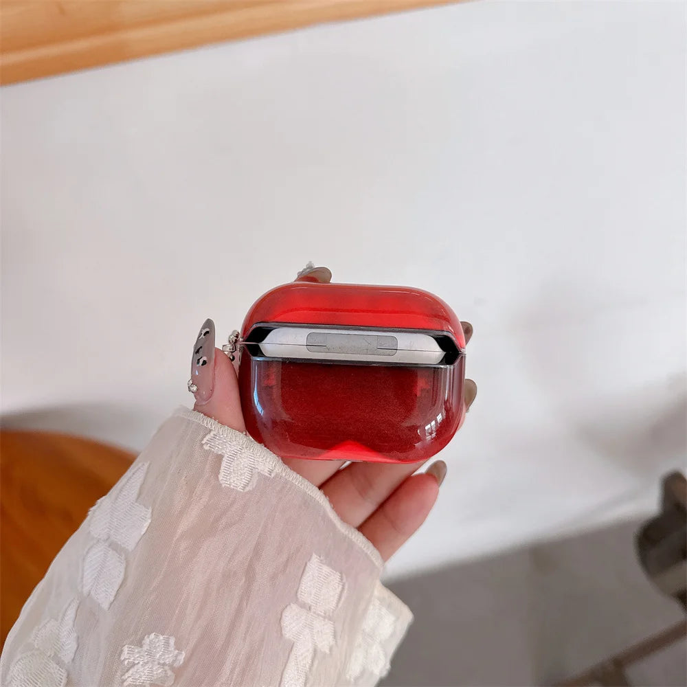 A hand holds a red luminous sand effect earphone case for AirPods against a white background.