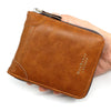 A brown men's vintage PU leather zipper card wallet is held in a hand.