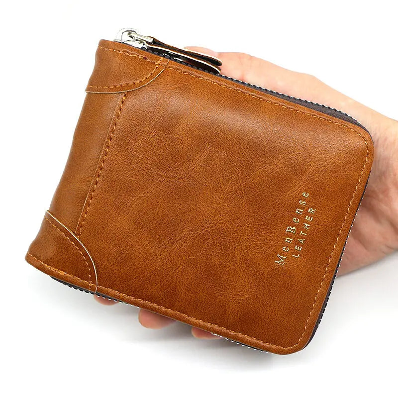 A brown men's vintage PU leather zipper card wallet is held in a hand.
