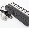 A black 7-port USB splitter hub with on/off switches and a white power cable.