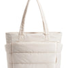A cream quilted tote bag with a long handle is shown against a white background.
