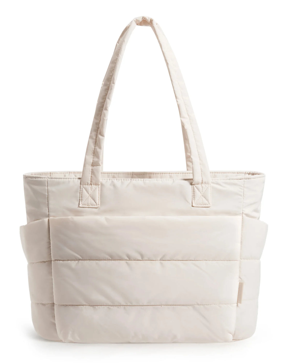 A cream quilted tote bag with a long handle is shown against a white background.