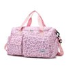 A pink leopard print travel duffel bag with shoulder straps and a shoe compartment.