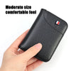 A hand holds a black slim PU leather credit card wallet for men, showing its size and texture.