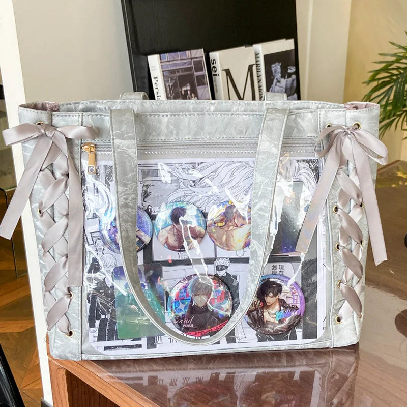 A silver transparent shoulder tote bag with a light pink ribbon, featuring various photo inserts.