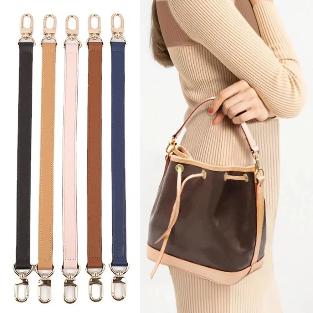 A brown leather shoulder strap is shown against a light beige sweater, highlighting its texture and length.