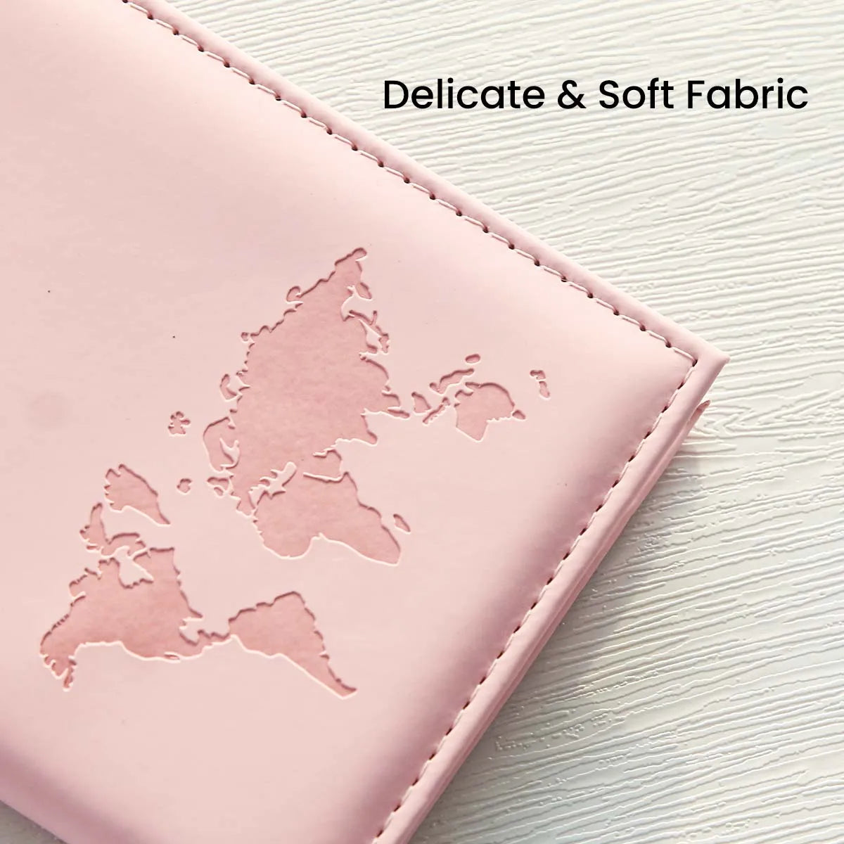 A pink slim PU passport holder featuring a cutout map of Europe on the cover.