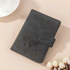 A dark gray passport wallet with a leather-like texture and a world map design is shown on a light background.