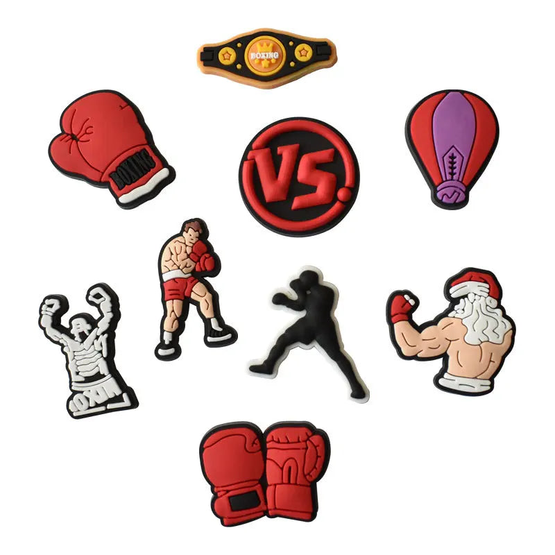 A collection of decorative shoe charms and pins featuring boxing themes, including gloves, faces, and various emblems.