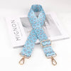 Light blue floral patterned diagonal strap for bags displayed on a white box.