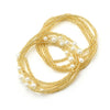 Gold belly bead chains with pearl accents arranged in intertwined loops.