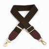 A dark brown canvas cotton bag strap with gold-colored metal hooks, shown in an 'X' shape.