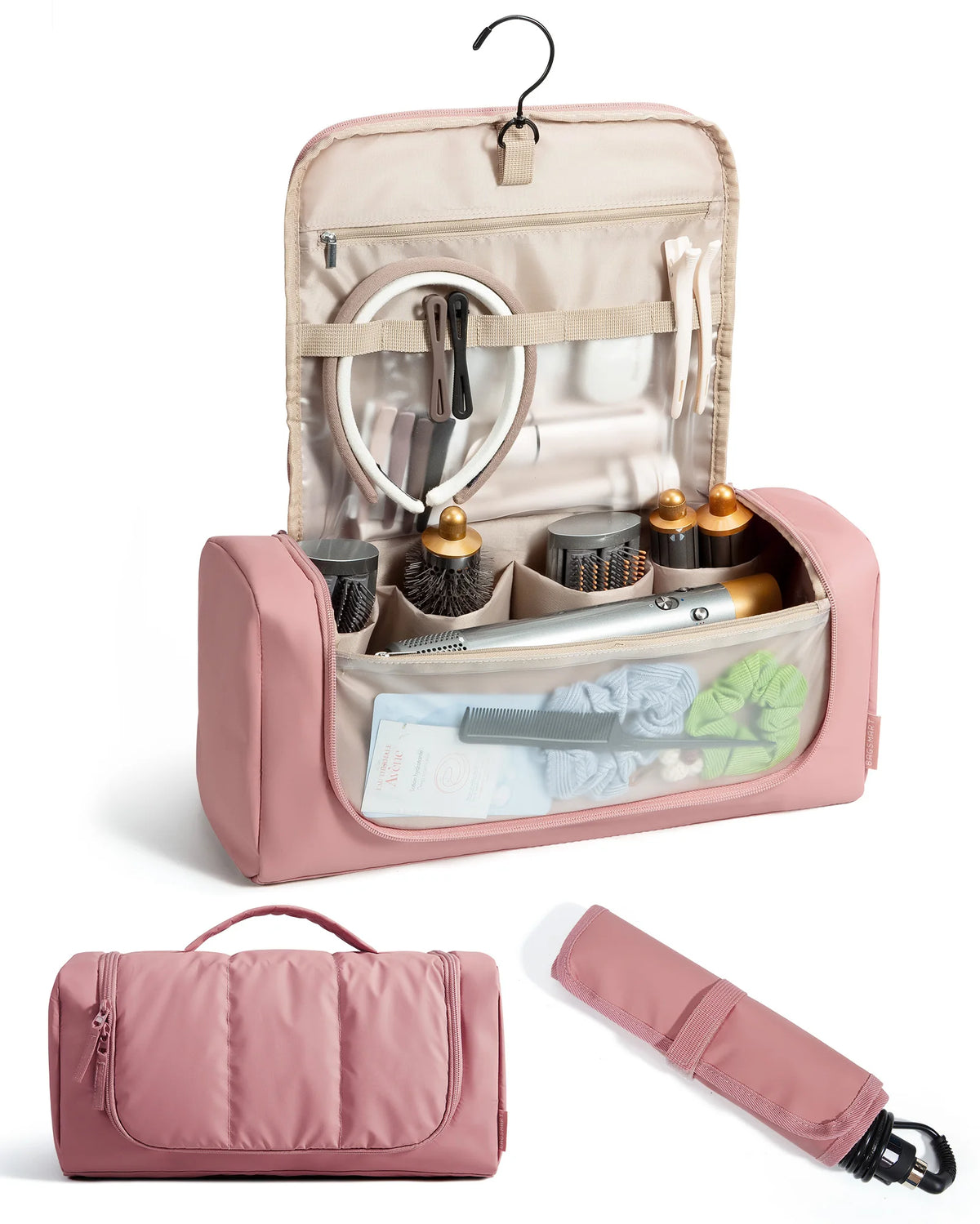 Estuche de viaje rosa para herramientas de peinado con gancho colgante, mostrando diversos utensilios y una brocha de maquill