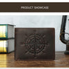 A dark brown leather wallet featuring an engraved compass design, displayed on a wooden surface.