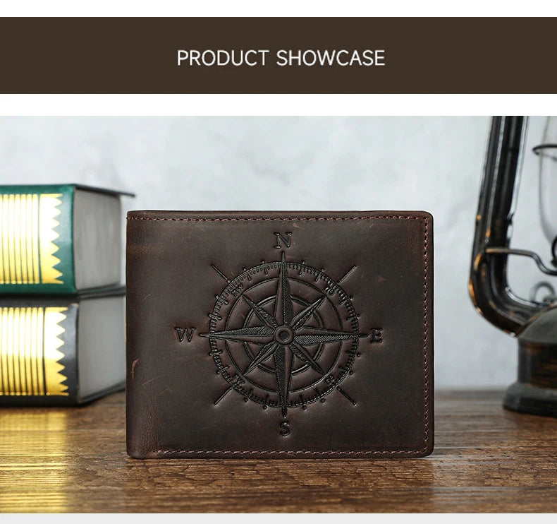 A dark brown leather wallet featuring an engraved compass design, displayed on a wooden surface.