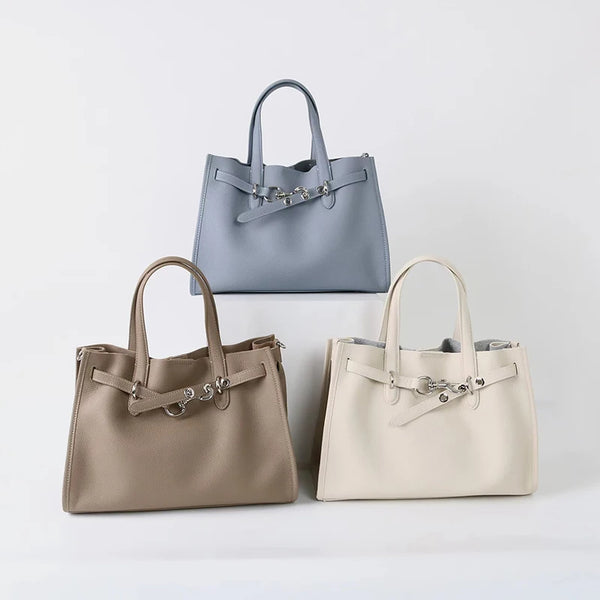 A set of three genuine leather women's shoulder tote bags in gray, beige, and cream.