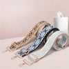 A set of replacement bag straps in various patterns including brown, blue, and light blue, displayed on a white surface.