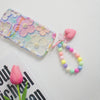A colorful bead keychain featuring pink and yellow hearts on a string with an O-ring clip.