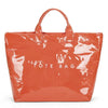 A clear orange waterproof PVC tote bag with a leather handle.