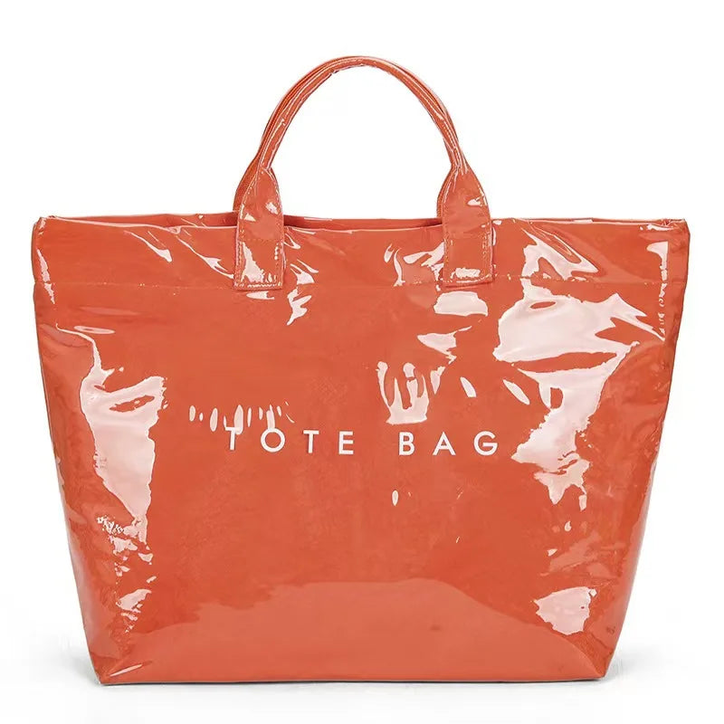 A clear orange waterproof PVC tote bag with a leather handle.