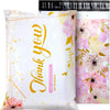 White poly mailer bag with gold lettering and a floral pattern featuring pink and yellow flowers.