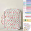A white quilted floral Bible cover with a pink ribbon and pen holder is shown against a light background.