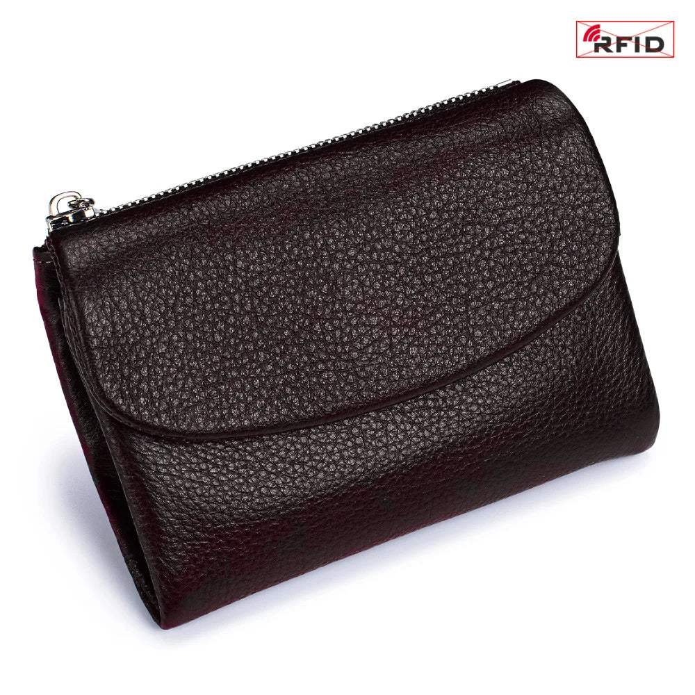 A dark burgundy genuine leather mini card holder wallet with a zippered closure.