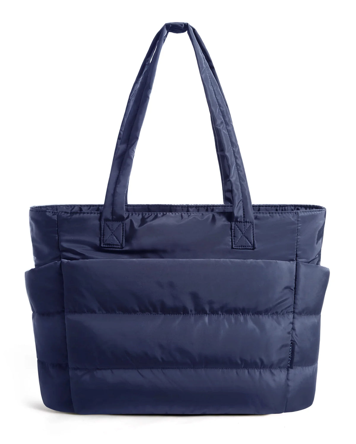 A navy blue quilted tote bag with a handle is shown against a white background.