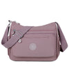 A mauve waterproof nylon crossbody shoulder bag with a strap and flap.