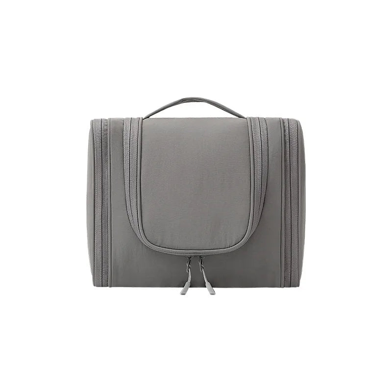 A gray waterproof hanging toiletry bag with a handle and strap.