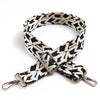 A black and white patterned jacquard strap for an adjustable wide crossbody bag.