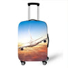 A silver suitcase with a blue sky background featuring an airplane in flight.