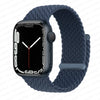 A dark blue braided stretch band worn around an Apple Watch.