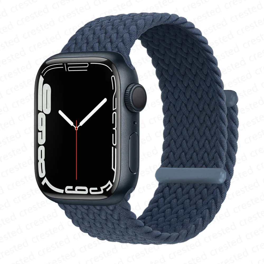 A dark blue braided stretch band worn around an Apple Watch.