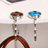 Silver-toned acrylic foldable hooks with round blue and amber gemstone accents