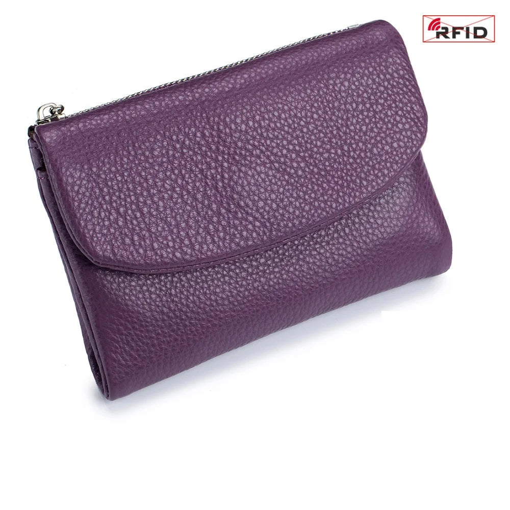 A purple genuine leather mini card holder wallet with a zipper closure.