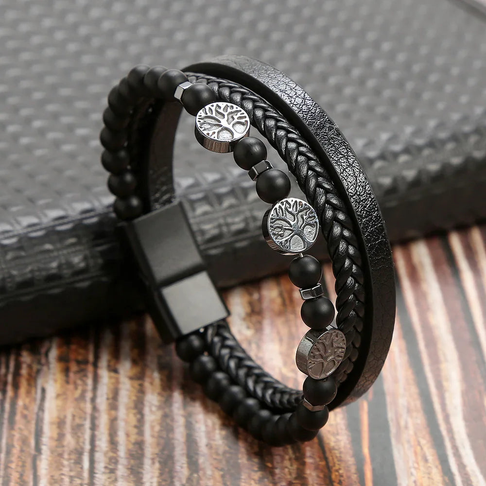 A black leather bracelet featuring multiple strands and tiger eye beads resting on a dark surface.