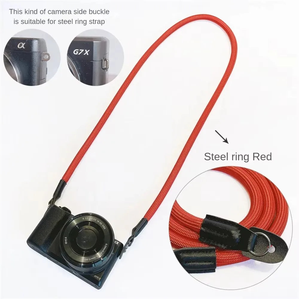 A red camera strap with a buckle suitable for steel ring straps, shown alongside various camera models.