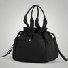 A black insulated drawstring lunch bag with multiple pockets is shown against a light gray background.