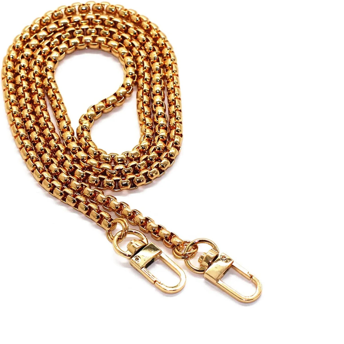 Gold stainless steel diamond-cut curb chain bag strap coiled and displayed on a white background