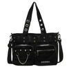 Black nylon shoulder bag with silver rivets and chain detail