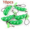 Ten green oval silicone fidget toys attached to metal chains and strings for keychains