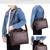 A brown genuine leather men's briefcase displayed on a man wearing a denim jacket.