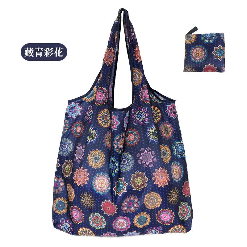 A reusable eco tote shopping bag featuring a dark blue fabric with colorful floral and geometric patterns.